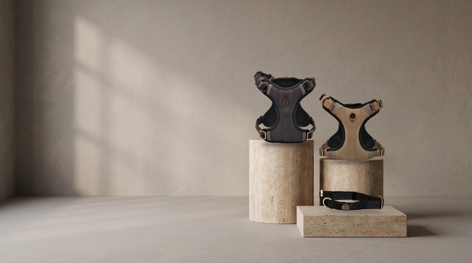 Graphite and Taupe L’Aplomb Tech Harnesses and a Graphite collar on travertine plinths